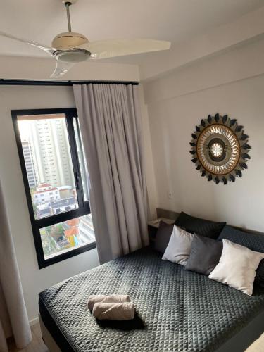 a bedroom with a bed with a mirror on the wall at Studio em São Paulo in Sao Paulo