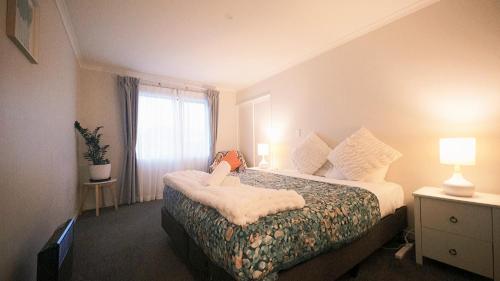 a hotel room with a bed and a window at Piwari Piata in Lake Tekapo