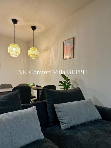 a living room with a couch and a table at NK Comfort Villa BEPPU in Beppu