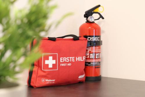 a red fire hydrant next to a fire extinguisher at VINoKAT Winestyle Living - Südliche Weinstraße in Kirrweiler