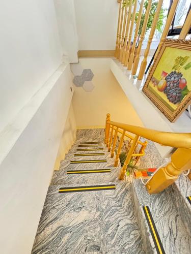 a staircase in a house with a painting on the floor at 大橋旁民宿 in Jincheng