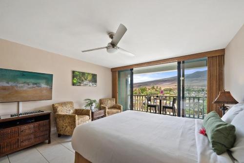 a bedroom with a large bed and a balcony at Lahaina Shores 306 · LS 306 Dream Maui Studio by the Beach Pool in Wainee