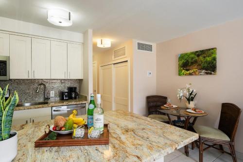 a kitchen with a table with a bowl of fruit on it at Lahaina Shores 306 · LS 306 Dream Maui Studio by the Beach Pool in Wainee