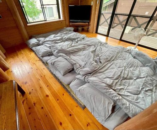 a large bed laying on the floor in a room at Karin in Minami Aso