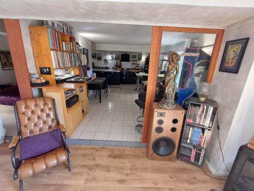 a view of a living room with a room with a table at Loft ravissant avec jacuzzi et parc in Orange