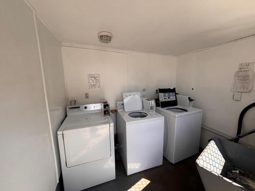 a laundry room with two washes and a washer and dryer at Westshore Holiday Park in Napier