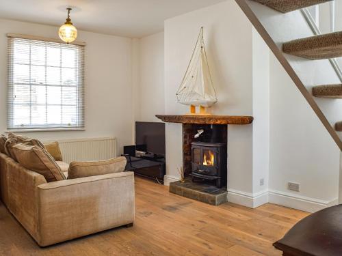 a living room with a couch and a fireplace at Waterloo Sunset in Bootle