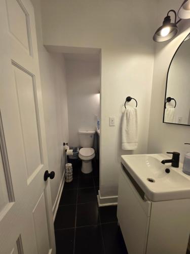 a bathroom with a white sink and a toilet at Grand House in Chicago