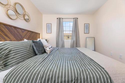 a bedroom with a large bed and a large window at Renovated 2BR *Central Location* in Johnson City