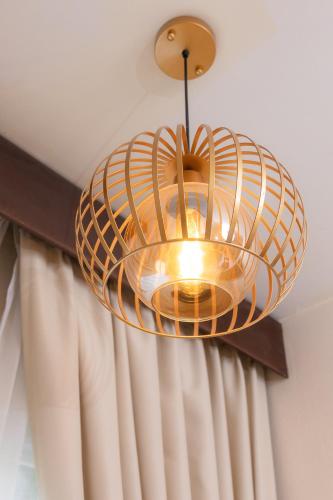 a light fixture hanging from a ceiling at Rasa Boutique Hotel Chiang Rai in Chiang Rai