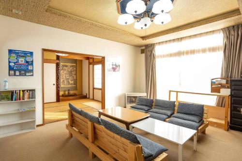 a living room with a couch and a table at 80s stay 釧路 in Kushiro