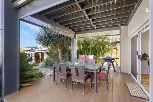 a patio with a table and chairs on a deck at Two-Storey Lakeview Retreat at Dunsborough Lakes in Dunsborough