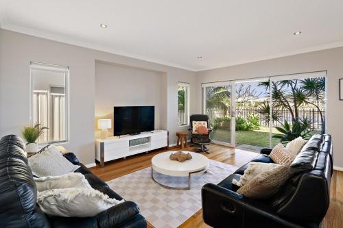 a living room with a couch and a table at Two-Storey Lakeview Retreat at Dunsborough Lakes in Dunsborough