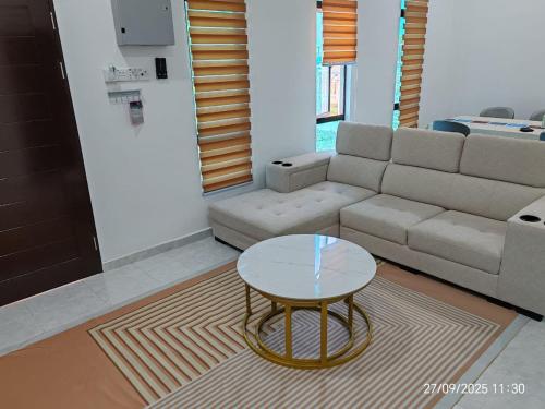 a living room with a couch and a table at Sri Midin Stay in Kuala Terengganu