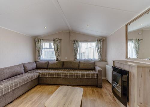 a living room with a couch and a table at Riverside Holiday Village in Uphill