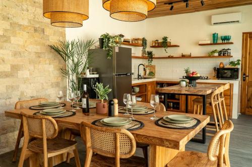 a dining room with a wooden table and chairs at Villa Samudra, Luxury and Comfort Villa by Balian Beach in Mantaak