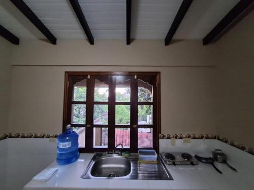a kitchen counter with a sink and a window at Apartment in Copán Ruinas in Copan Ruinas