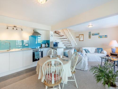a kitchen and living room with a table and chairs at The Lookout in Torquay