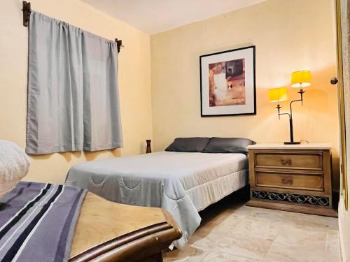a bedroom with two beds and a dresser and a window at Hotel 305 in Parras de la Fuente