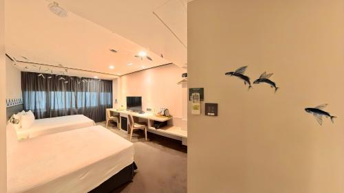a hotel room with two beds and a desk at Energy Inn in Taipei