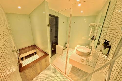 a bathroom with a shower and a toilet and a sink at Energy Inn in Taipei