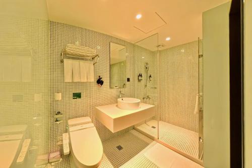 a bathroom with a toilet and a sink and a shower at Energy Inn in Taipei