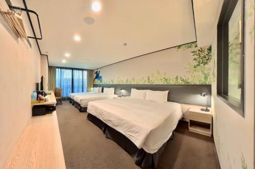 a hotel room with two beds and a window at Energy Inn in Taipei