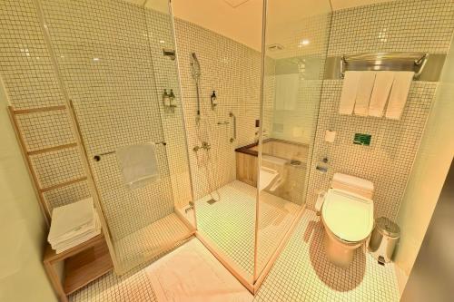 a bathroom with a shower and a toilet at Energy Inn in Taipei