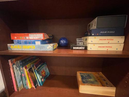 a book shelf with a stack of books and a box at Private Estate, walk to Princeton downtown, 3 Bedrooms, 2 Bath, with Free Parking in Princeton