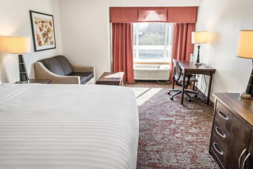a hotel room with a bed and a desk at Crystal Inn Hotel & Suites - Salt Lake City in Salt Lake City