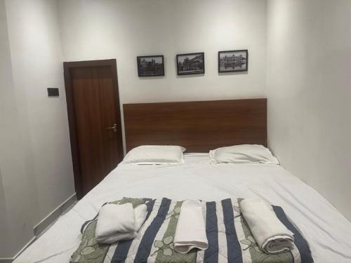 a bedroom with a bed with towels on it at a28 ORANGE BRICKS in Kolkata