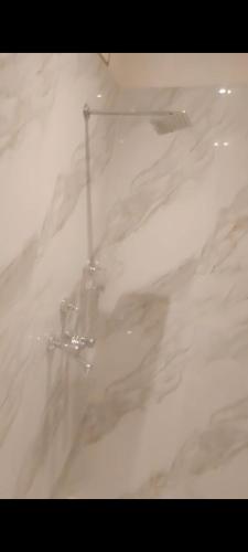 a white marble counter top in a bathroom at a28 ORANGE BRICKS - Park Street - New Market in Kolkata