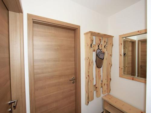 a room with a wooden door and a mirror at Apartment in Aschau near Ski Slopes in Aschau