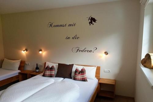 a bedroom with a bed with a quote on the wall at Apartment in Aschau near Ski Slopes in Aschau