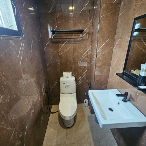a bathroom with a toilet and a sink at Secrets - Pattaya in Pattaya