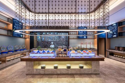 a store lobby with a buffet of food on display at Novotel Shanghai Hongqiao International Airport in Shanghai