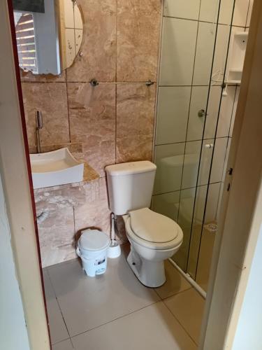 a bathroom with a toilet and a sink at Pousada Musleh in Rio Grande