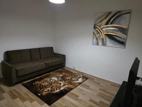 a living room with a couch and a painting at Cozy one bedroom flat in Chatham