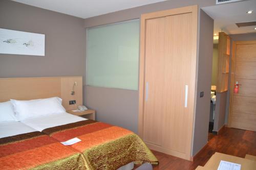 Ένα ή περισσότερα κρεβάτια σε δωμάτιο στο Hotel Vilar Riu de Baix