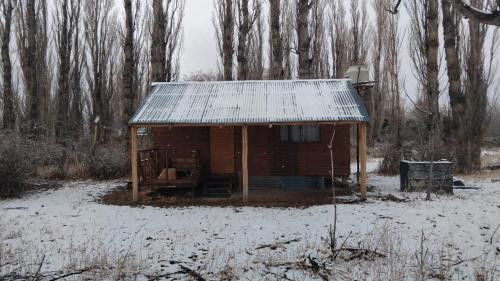 a small building with a tin roof in the snow at Cabaña La 40 "Relax y descanso en zona de chacras" in Buta Ranquil