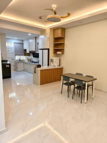 a kitchen and dining room with a table and chairs at Serai Homestay in Dungun