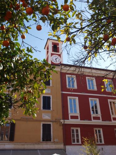 a building with a clock tower on top of it at Ostello Palazzo Nizza in Massa