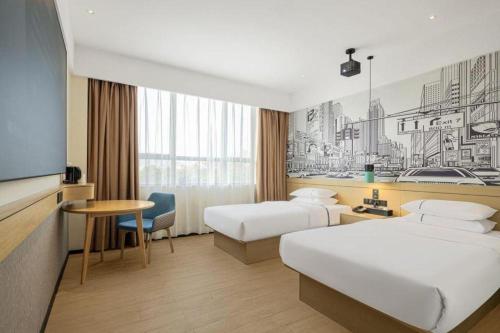 a hotel room with two beds and a tv at City Comfort Inn Liuzhou Longtan Park Ma'anshan Baiyun in Liuzhou
