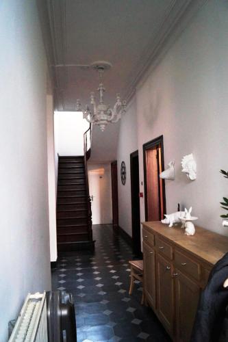 a hallway with a staircase and a room with a stair case at De Oude Pastorij in Maarkedal