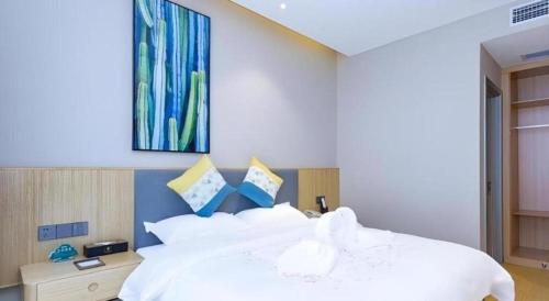 Ένα ή περισσότερα κρεβάτια σε δωμάτιο στο GreenTree Inn Express Fuzhou Minhou County Mindu Custom Park