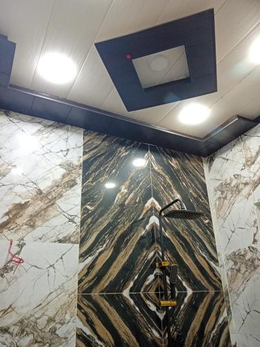 a room with a marble floor and a ceiling at Al IMRAN villa 2 bedroom apartment in Lahore