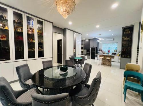 a dining room with a glass table and chairs at 3KM to UTAR Sungai Long Party House 45Pax 20Car in Kajang