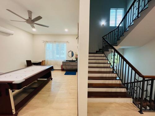 a staircase in a house with a table and a stair case at 3KM to UTAR Sungai Long Party House 45Pax 20Car in Kajang