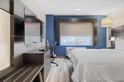 a hotel room with a bed and a desk and a window at Holiday Inn Express - Sunnyvale - Silicon Valley by IHG in Sunnyvale