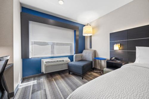 a hotel room with a bed and a chair and a window at Holiday Inn Express - Sunnyvale - Silicon Valley by IHG in Sunnyvale